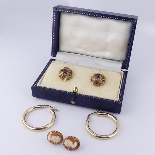 329 - A pair of 9ct gold and garnet Earrings, the textured pierced circular mounts claw set with a central... 