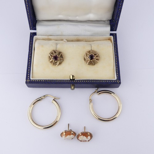 329 - A pair of 9ct gold and garnet Earrings, the textured pierced circular mounts claw set with a central... 