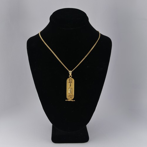 271 - An 18ct yellow gold Egyptian Pendant, of typical design with hieroglyphs front and reverse, 4.2cm lo... 