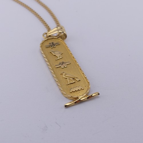 271 - An 18ct yellow gold Egyptian Pendant, of typical design with hieroglyphs front and reverse, 4.2cm lo... 