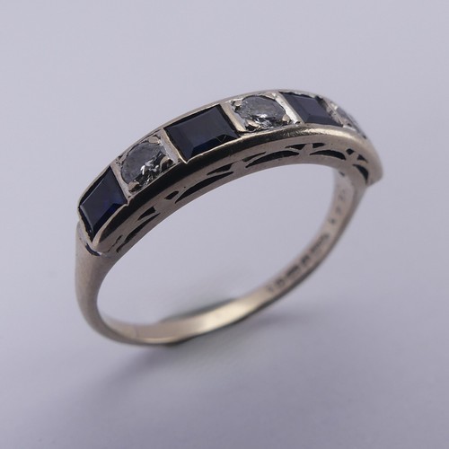 191 - A sapphire and diamond half hoop Eternity Ring, channel set with four calibre cut sapphires and thre... 