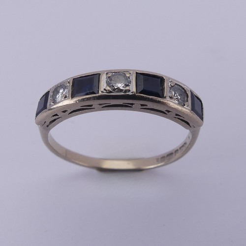 191 - A sapphire and diamond half hoop Eternity Ring, channel set with four calibre cut sapphires and thre... 