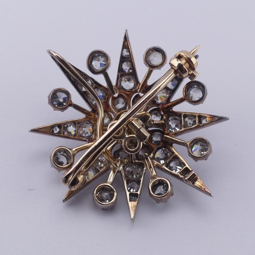 330 - A Victorian diamond star Pendant / Brooch, the central cushion shaped old cut stone approx. 0.35ct, ... 