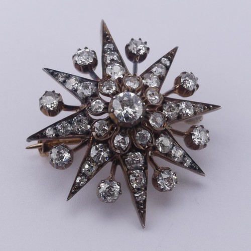 330 - A Victorian diamond star Pendant / Brooch, the central cushion shaped old cut stone approx. 0.35ct, ... 