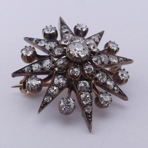 330 - A Victorian diamond star Pendant / Brooch, the central cushion shaped old cut stone approx. 0.35ct, ... 