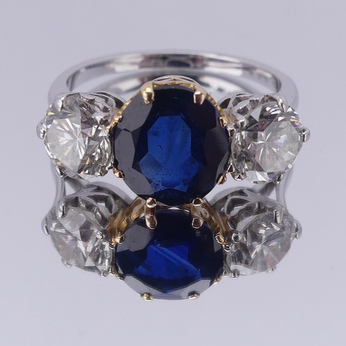 301 - A sapphire and diamond three stone Ring, the central cushion shaped facetted sapphire, approx. 2.6ct... 