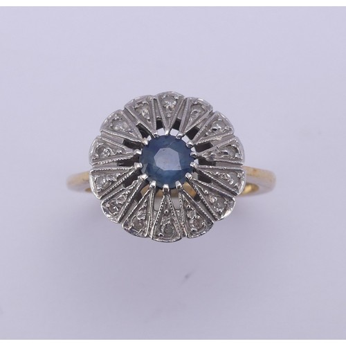 194 - A sapphire and diamond Dress Ring, the pale circular facetted central sapphire approx. 5mm diameter,... 