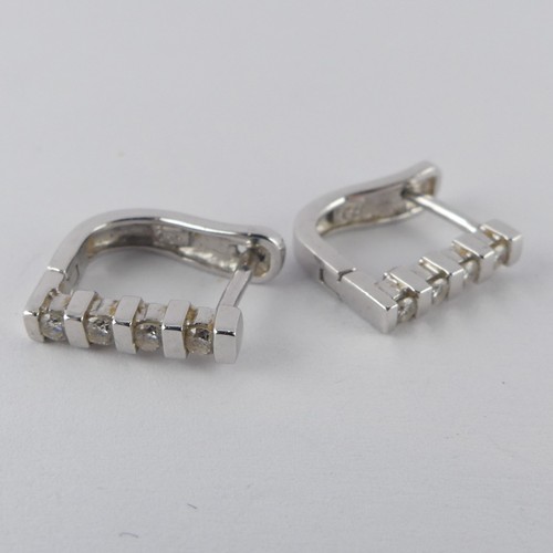 332 - A pair of 18ct white gold hoop Earrings, the fronts set with four small brilliant cut diamonds, 12mm... 