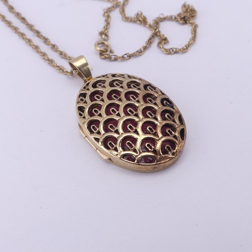 275 - A 9ct yellow gold oval hinged Locket Pendant, with lattice pierced front, 3.5cm long exc. bale, on a... 