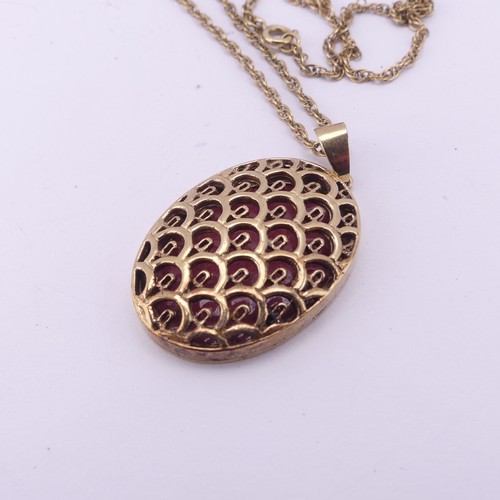 275 - A 9ct yellow gold oval hinged Locket Pendant, with lattice pierced front, 3.5cm long exc. bale, on a... 