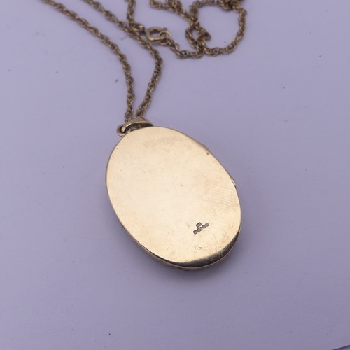 275 - A 9ct yellow gold oval hinged Locket Pendant, with lattice pierced front, 3.5cm long exc. bale, on a... 