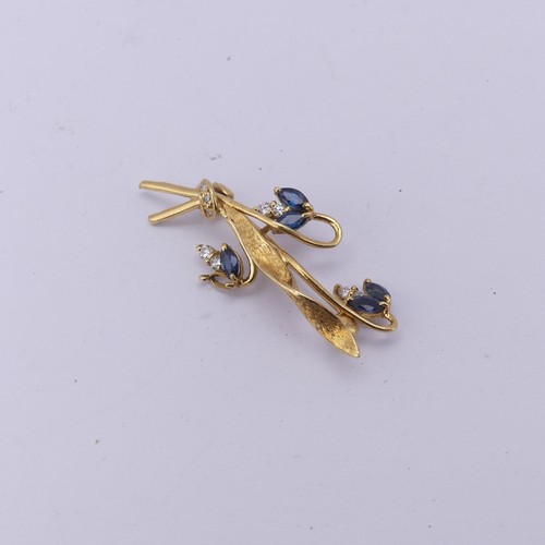 335 - An 18ct yellow gold foliate spray Brooch, the three flower heads set sapphires and diamonds, 4cm lon... 