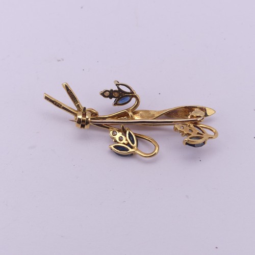 335 - An 18ct yellow gold foliate spray Brooch, the three flower heads set sapphires and diamonds, 4cm lon... 