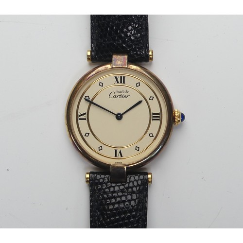 143 - A Must de Cartier silver gilt quartz Vermeil Wristwatch, model no: 590003, the circular ivory colour... 