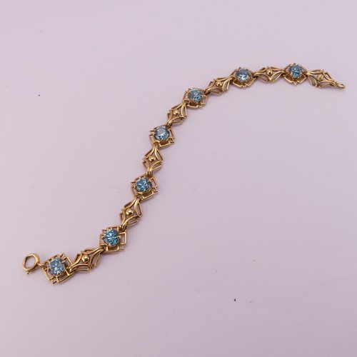 304 - A blue topaz Bracelet, the seven circular facetted stones 5.85mm diameter, four claw set in 18ct yel... 