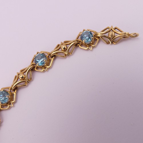 304 - A blue topaz Bracelet, the seven circular facetted stones 5.85mm diameter, four claw set in 18ct yel... 