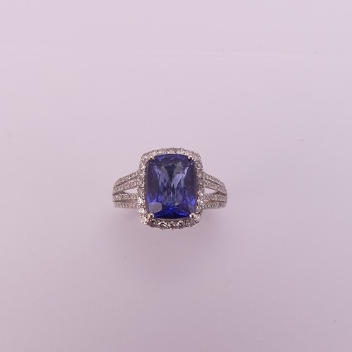 199 - A modern tanzanite and diamond Dress Ring, the rectangular stone 10.3mm x 8mm claw set in the corner... 