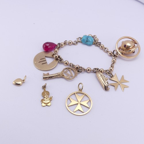 305 - A 9ct yellow gold Charm Bracelet, suspended with a turquoise matrix, a pear shaped ruby glass charm,... 