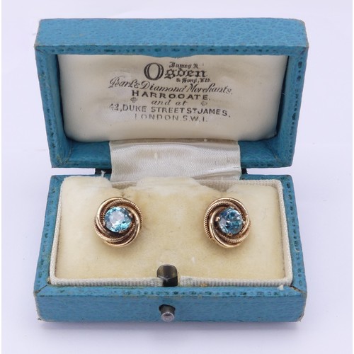 337 - A pair of blue topaz Earrings, the circular facetted stones approx. 5.8mm diameter four claw set in ... 