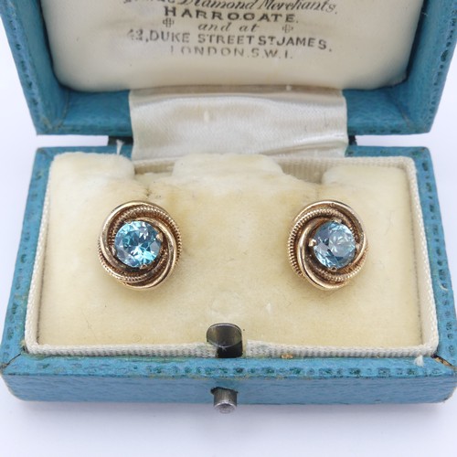 337 - A pair of blue topaz Earrings, the circular facetted stones approx. 5.8mm diameter four claw set in ... 