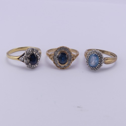 203 - A sapphire and diamond cluster Ring, mounted with a diamond point on the split shoulders in 18ct yel... 