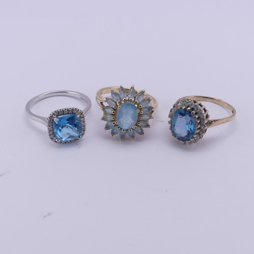 206 - A topaz and diamond cluster Ring, mounted in 14ct white gold, Size O, together with a starburst blue... 