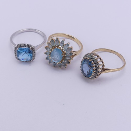 206 - A topaz and diamond cluster Ring, mounted in 14ct white gold, Size O, together with a starburst blue... 