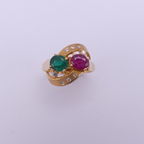 208 - A contemporary ruby and emerald Ring, the oval facetted stones, each approx. 0.7ct, claw set within ... 