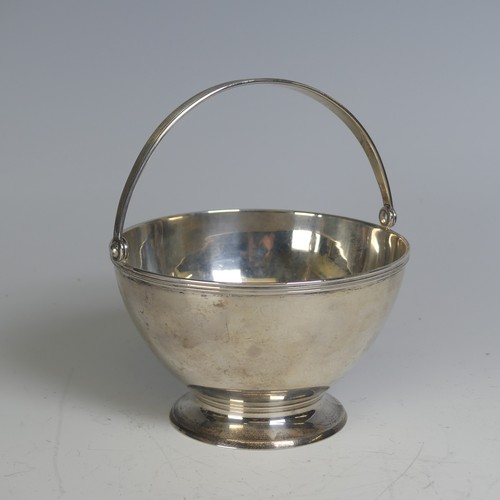 100 - Tiffany & Co.; An Art Deco silver Sugar Basket, of circular form, the swing handle with reeded d... 