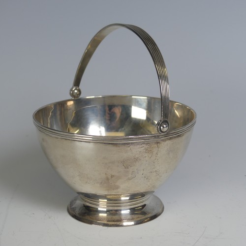 100 - Tiffany & Co.; An Art Deco silver Sugar Basket, of circular form, the swing handle with reeded d... 