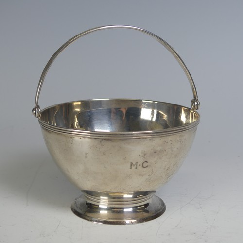 100 - Tiffany & Co.; An Art Deco silver Sugar Basket, of circular form, the swing handle with reeded d... 