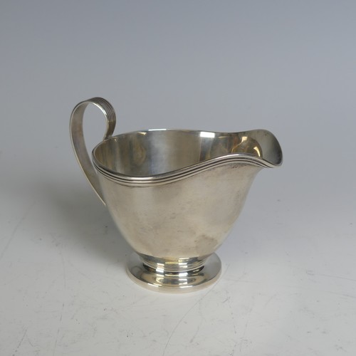 99 - Tiffany & Co.; An Art Deco silver Cream Jug, the handle with reeded decoration, circular foot wi... 