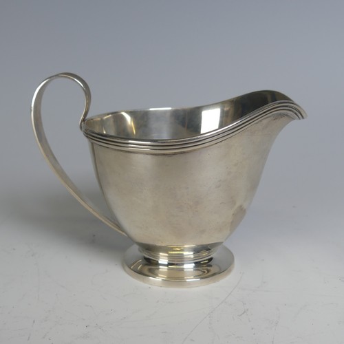 99 - Tiffany & Co.; An Art Deco silver Cream Jug, the handle with reeded decoration, circular foot wi... 