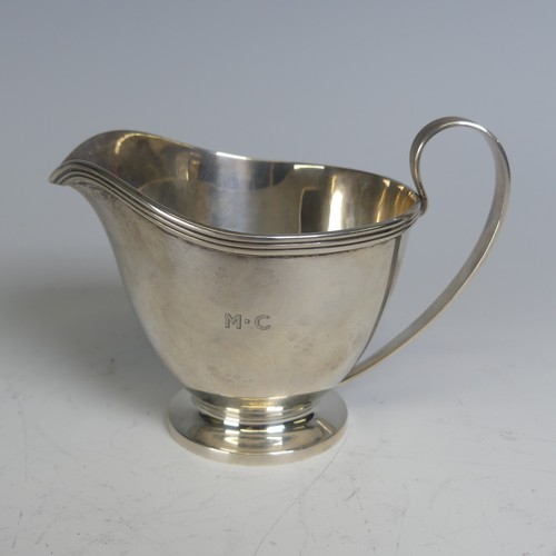 99 - Tiffany & Co.; An Art Deco silver Cream Jug, the handle with reeded decoration, circular foot wi... 