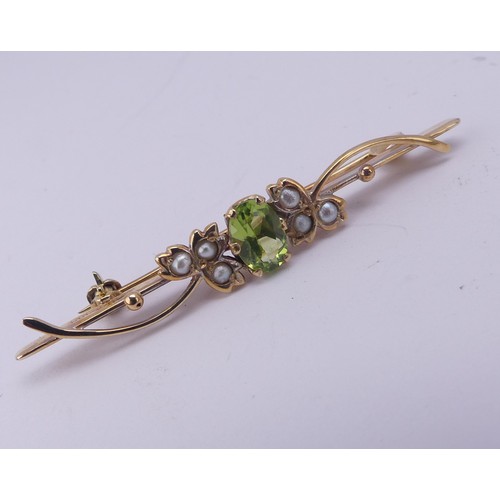 319 - A peridot and seed pearl Bar Brooch, mounted in 9ct yellow gold, together with a pair of pear shaped... 