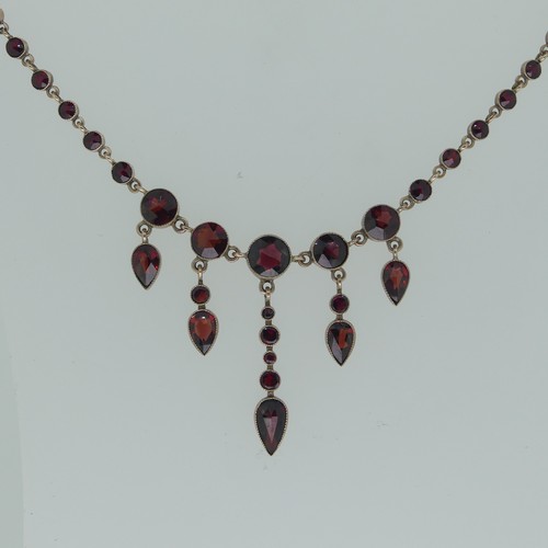 280 - A facetted garnet Necklace, the centre with five graduated pear shaped drops, millegrain set in unma... 