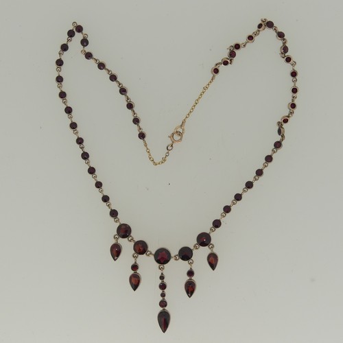 280 - A facetted garnet Necklace, the centre with five graduated pear shaped drops, millegrain set in unma... 