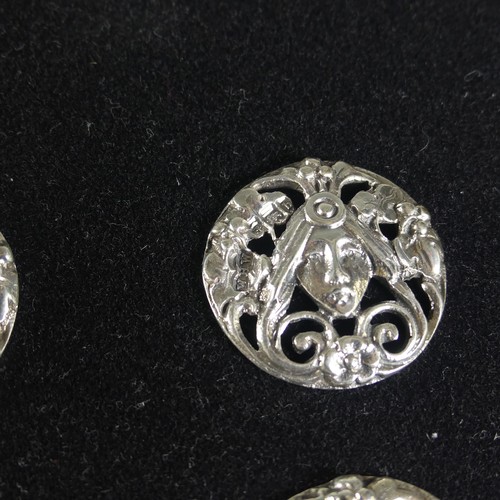 116 - A set of six Edwardian silver Buttons, Birmingham 1901, pierced with a mask and flowers in the Art N... 