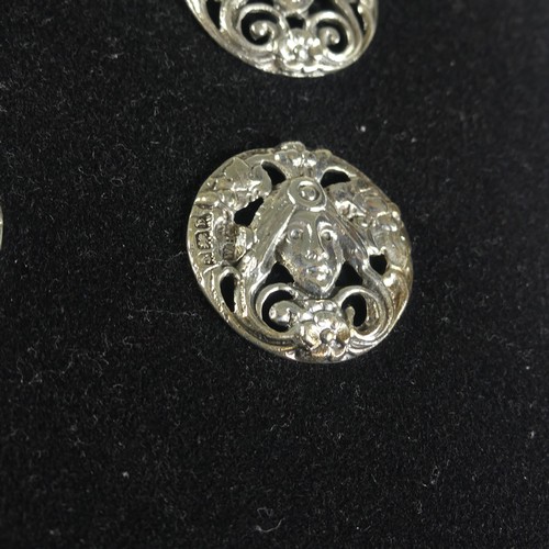 116 - A set of six Edwardian silver Buttons, Birmingham 1901, pierced with a mask and flowers in the Art N... 