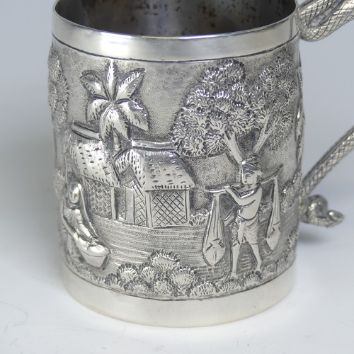 100A - An early 20thC Eastern silver Mug, possibly Chinese / Burmese, the base marked 'T.P. 90', with conti... 