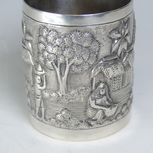 100A - An early 20thC Eastern silver Mug, possibly Chinese / Burmese, the base marked 'T.P. 90', with conti... 