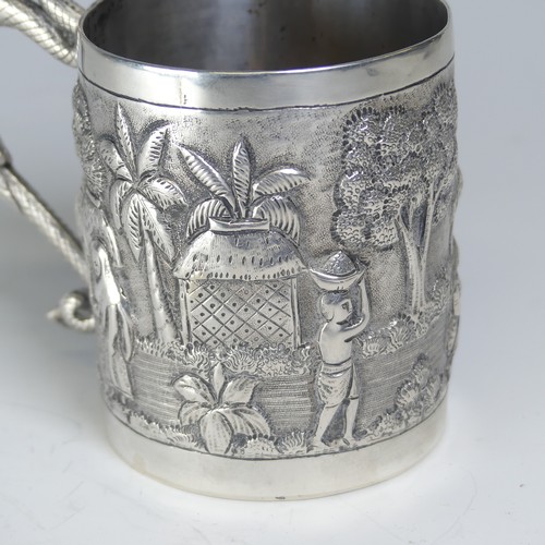 100A - An early 20thC Eastern silver Mug, possibly Chinese / Burmese, the base marked 'T.P. 90', with conti... 