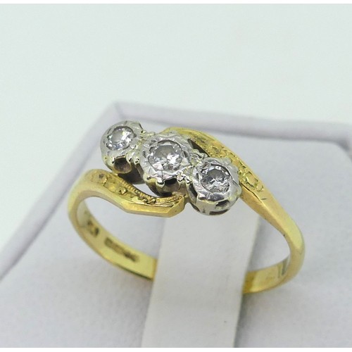 175 - A three stone diamond Ring, illusion set on the cross in 18ct yellow and white gold, Size L½, togeth... 