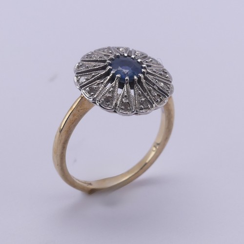 194 - A sapphire and diamond Dress Ring, the pale circular facetted central sapphire approx. 5mm diameter,... 