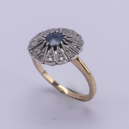 194 - A sapphire and diamond Dress Ring, the pale circular facetted central sapphire approx. 5mm diameter,... 