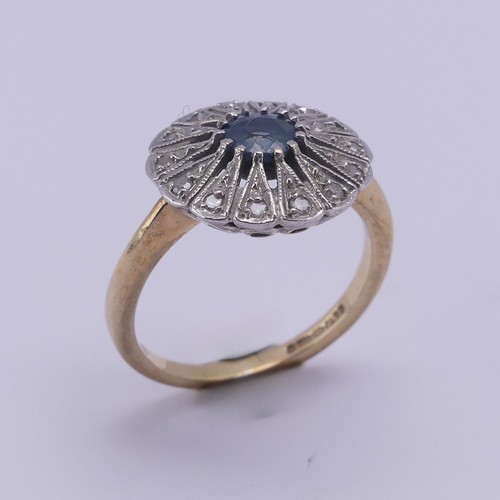 194 - A sapphire and diamond Dress Ring, the pale circular facetted central sapphire approx. 5mm diameter,... 