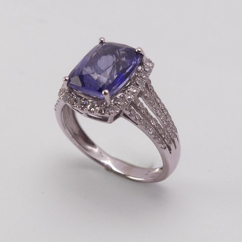 199 - A modern tanzanite and diamond Dress Ring, the rectangular stone 10.3mm x 8mm claw set in the corner... 