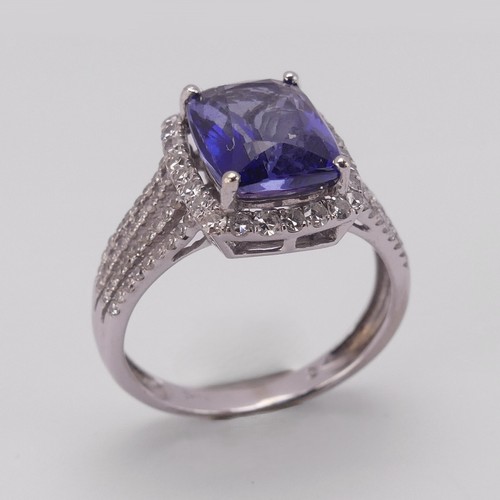 199 - A modern tanzanite and diamond Dress Ring, the rectangular stone 10.3mm x 8mm claw set in the corner... 