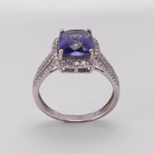 199 - A modern tanzanite and diamond Dress Ring, the rectangular stone 10.3mm x 8mm claw set in the corner... 