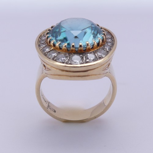 200 - A blue topaz and diamond Dress Ring, the circular facetted topaz approx. 12.3mm diameter, surrounded... 